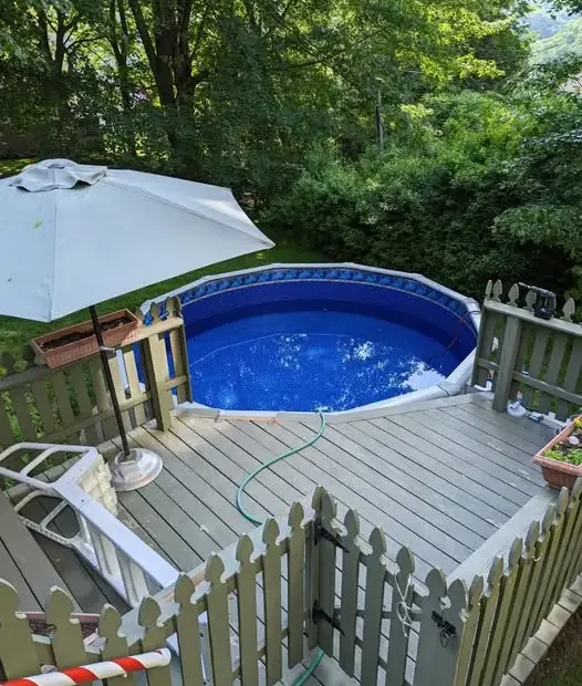 Newly installed swimming pool from Strawbridge Pools with fence.