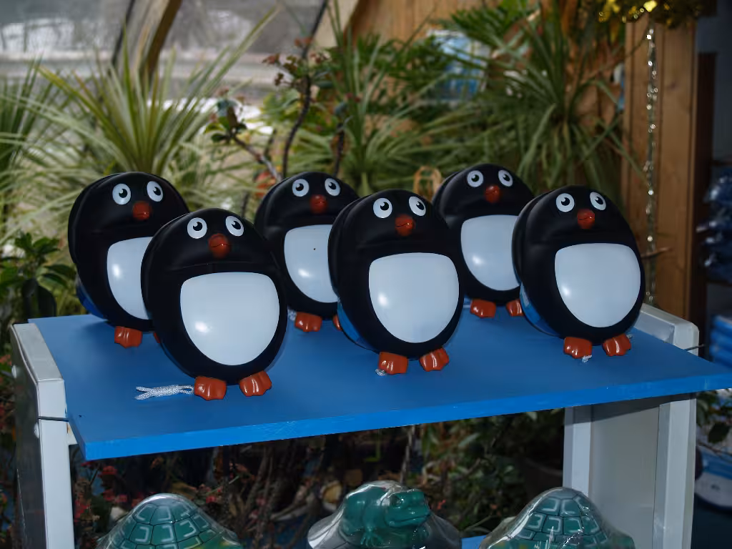 Black and white floats that are penguin shaped for the pool.